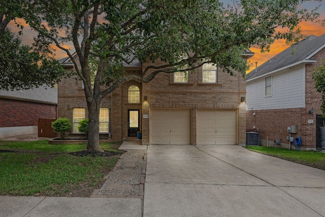 2104 Faldo Ln, Round Rock, TX 78664 - view of front of property featuring a garage, driveway, brick siding, and central AC unit