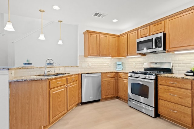 2104 Faldo Ln, Round Rock, TX 78664 - kitchen featuring stainless steel appliances, a sink, a peninsula, light stone countertops, and recessed lighting