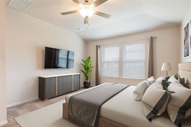 bedroom featuring ceiling fan, visible vents, vaulted ceiling, baseboards, and light carpet