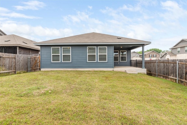 back of property featuring a lawn, a patio, a shingled roof, and a fenced backyard