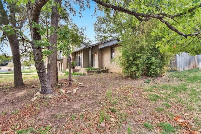 view of front of home featuring fence