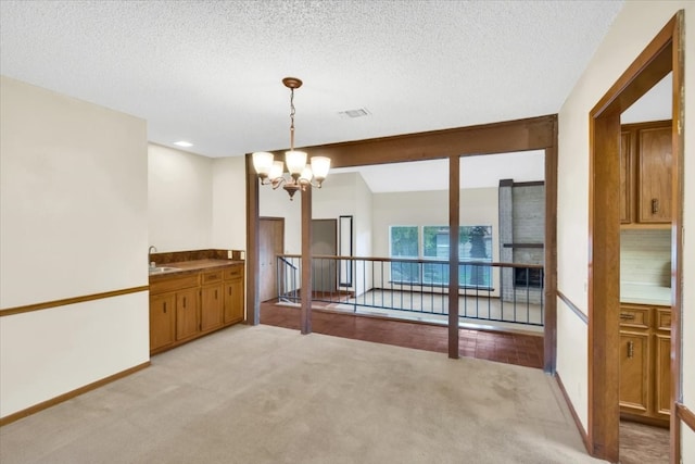 2015 Mistywood Dr, Austin, TX 78746 - unfurnished dining area featuring a chandelier, light carpet, and a textured ceiling