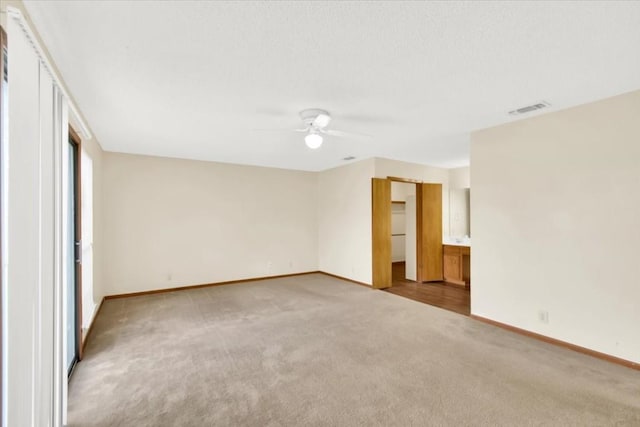 unfurnished bedroom featuring baseboards, ceiling fan, carpet flooring, and visible vents
