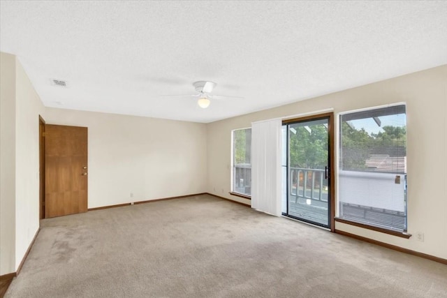 carpeted empty room with ceiling fan and baseboards