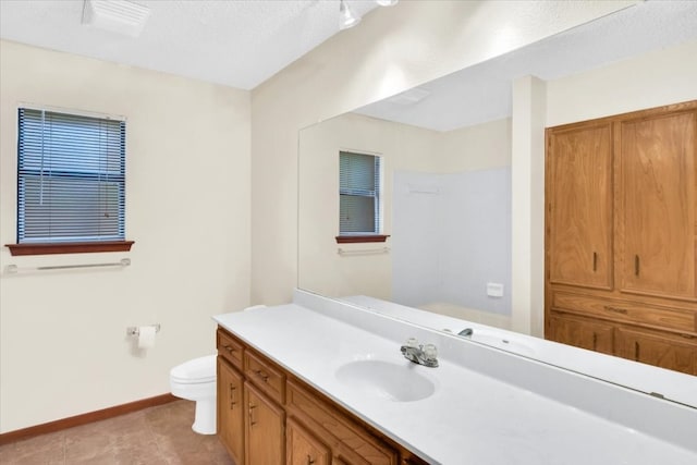bathroom with walk in shower, vanity, toilet, tile patterned floors, and baseboards