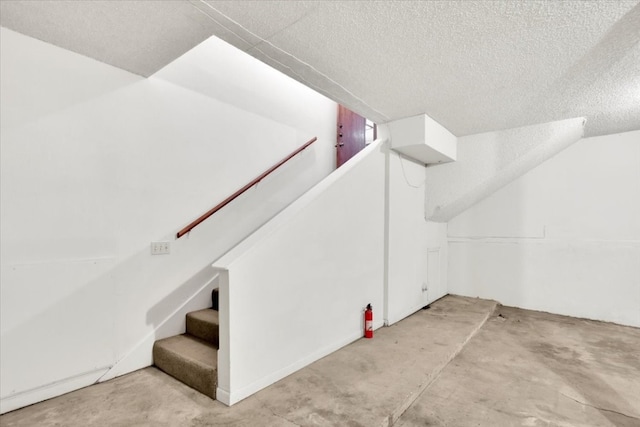 interior space with a textured ceiling and stairs