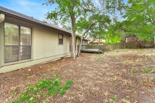 view of yard with fence and a deck
