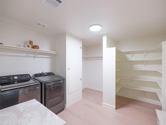 11224 Pickard Ln, Austin, TX 78748 - laundry room with washer and dryer and light wood-style floors