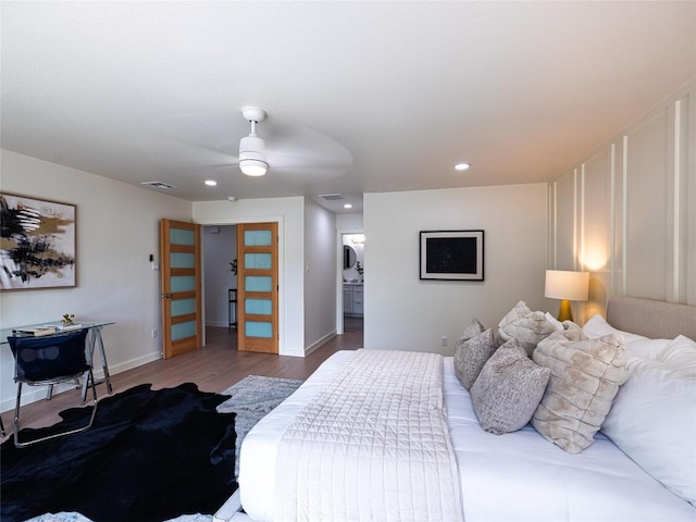 bedroom featuring baseboards, recessed lighting, wood finished floors, and visible vents