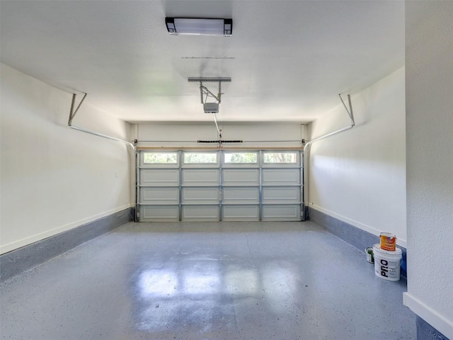 garage with baseboards and a garage door opener