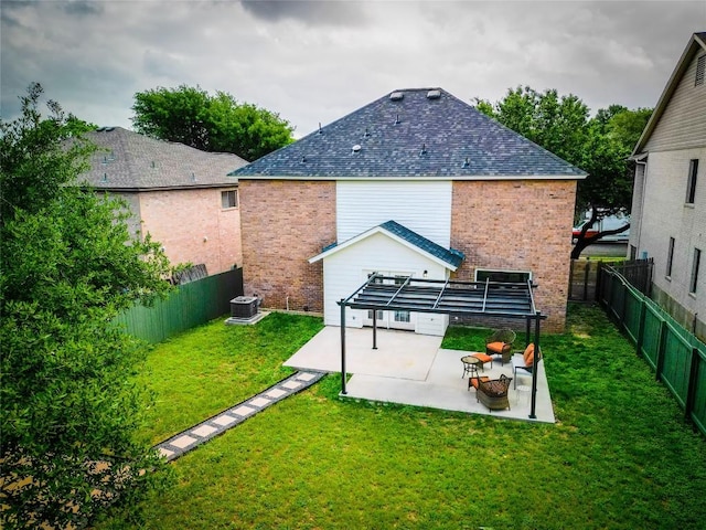 back of property with a patio, a fenced backyard, a lawn, and brick siding