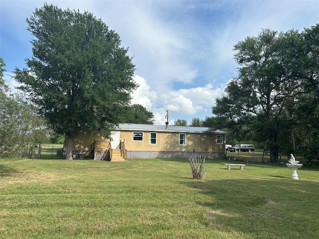 exterior space with fence and a front yard