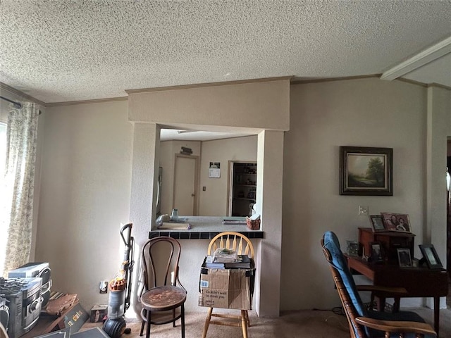 dining room featuring a textured ceiling, ornamental molding, and carpet