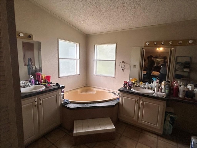 full bathroom with a textured ceiling, tile patterned flooring, a sink, and lofted ceiling