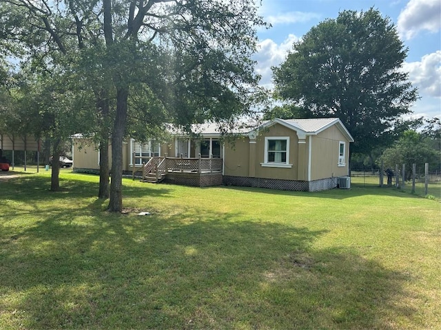 view of yard featuring fence, a wooden deck, and cooling unit