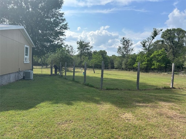 view of yard with fence and central AC unit