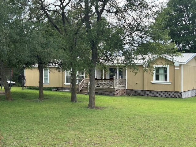 277 Mesquite Dr, Cedar Creek, TX 78612 - view of front of home featuring a deck and a front lawn