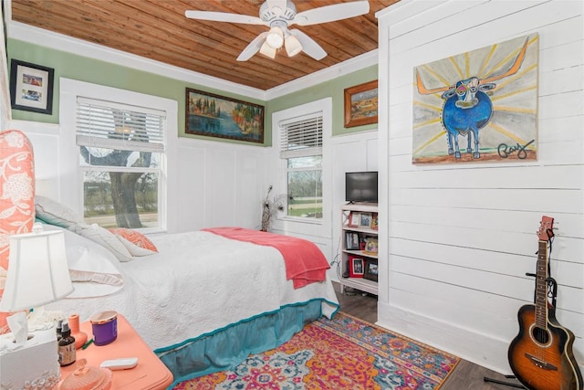 bedroom with wood finished floors, a ceiling fan, multiple windows, and wooden ceiling