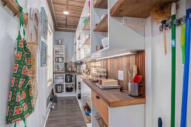 interior space with open shelves, butcher block countertops, wooden ceiling, and dark wood finished floors