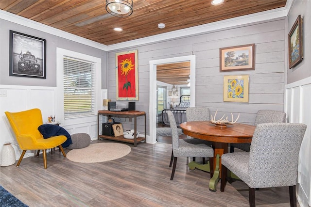 dining space with recessed lighting, wooden ceiling, wood finished floors, and a decorative wall