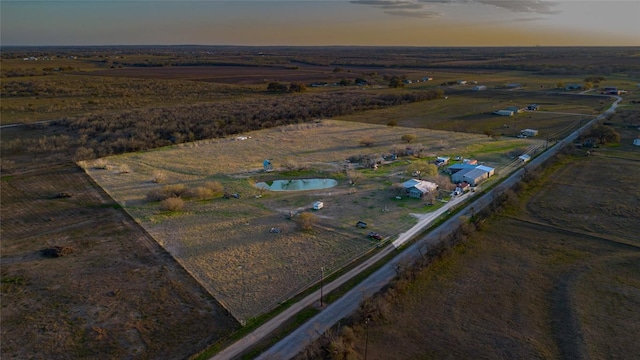 aerial view at dusk featuring a rural view
