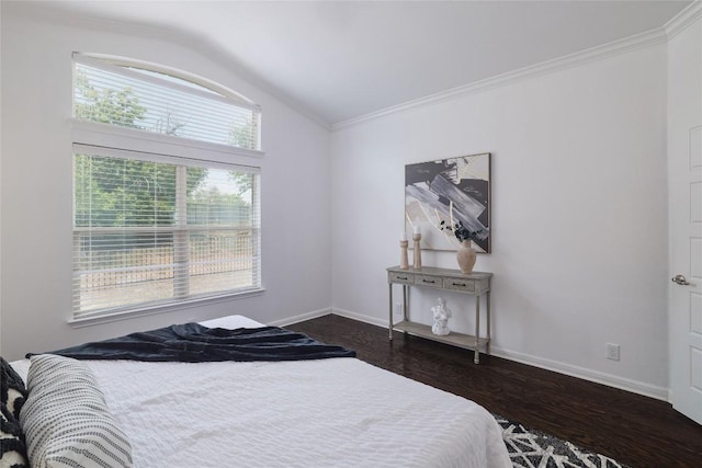 bedroom with crown molding, baseboards, vaulted ceiling, and dark wood-style floors
