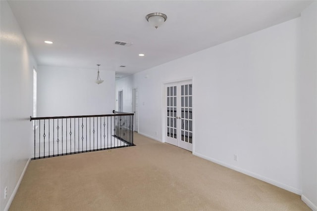carpeted empty room featuring baseboards, recessed lighting, and visible vents