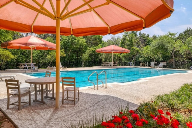 7300 Colina Vis Unit B, Austin, TX 78750 - community pool featuring a patio area and view of scattered trees