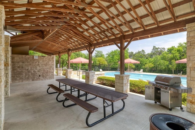 view of property's community featuring a patio area and a pool