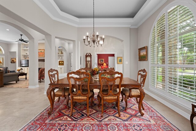 1901 Plantation Ct, Round Rock, TX 78681 - dining space with arched walkways, a ceiling fan, a raised ceiling, ornamental molding, and a chandelier