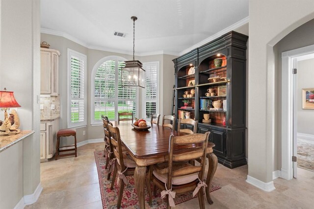 1901 Plantation Ct, Round Rock, TX 78681 - dining space with arched walkways, ornamental molding, baseboards, and a chandelier