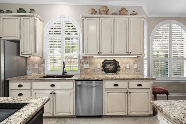 1901 Plantation Ct, Round Rock, TX 78681 - kitchen featuring stainless steel appliances, a sink, crown molding, tasteful backsplash, and light stone countertops