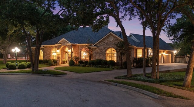 1901 Plantation Ct, Round Rock, TX 78681 - ranch-style home with driveway, a garage, brick siding, a front yard, and roof with shingles
