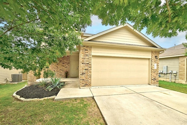 view of front of house featuring an attached garage, cooling unit, driveway, and brick siding