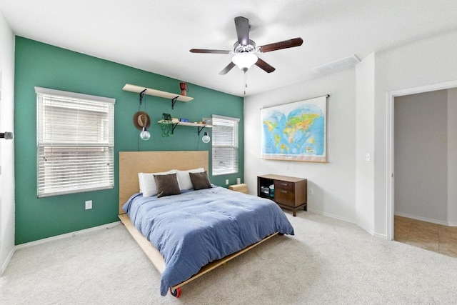 bedroom with carpet floors, multiple windows, baseboards, and ceiling fan