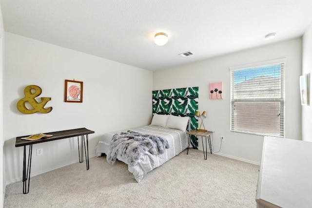 bedroom with carpet floors, baseboards, and visible vents
