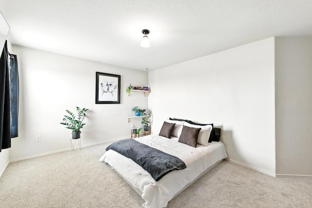 bedroom featuring baseboards and carpet