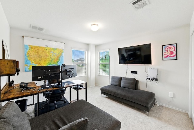 carpeted home office featuring visible vents and baseboards