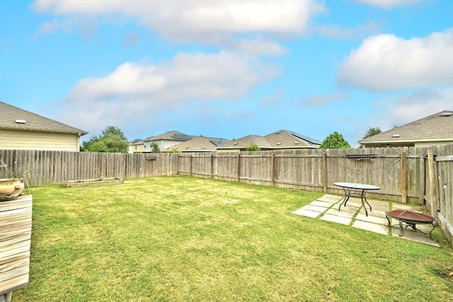 view of yard featuring a patio and a fenced backyard