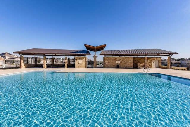 pool featuring a gazebo, fence, and a patio area