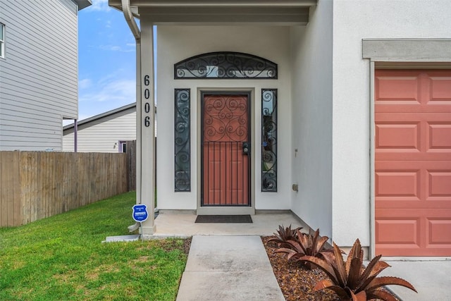 6006 Seville Dr, Austin, TX 78724 - view of exterior entry with an attached garage and stucco siding