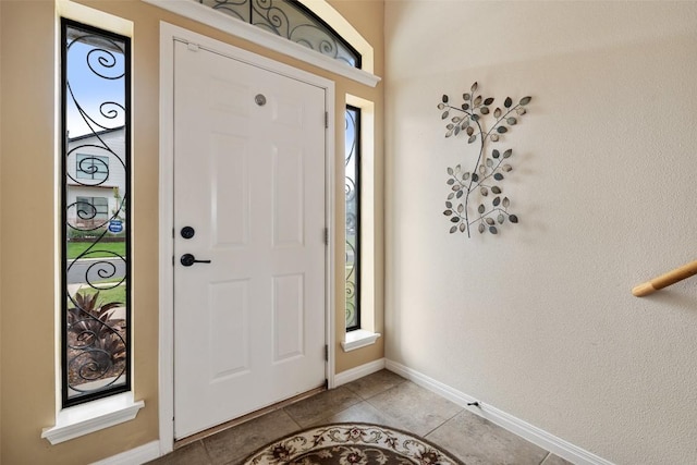 6006 Seville Dr, Austin, TX 78724 - entryway with light tile patterned floors and baseboards
