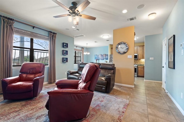 6006 Seville Dr, Austin, TX 78724 - living room with a ceiling fan, a chandelier, and light tile patterned flooring