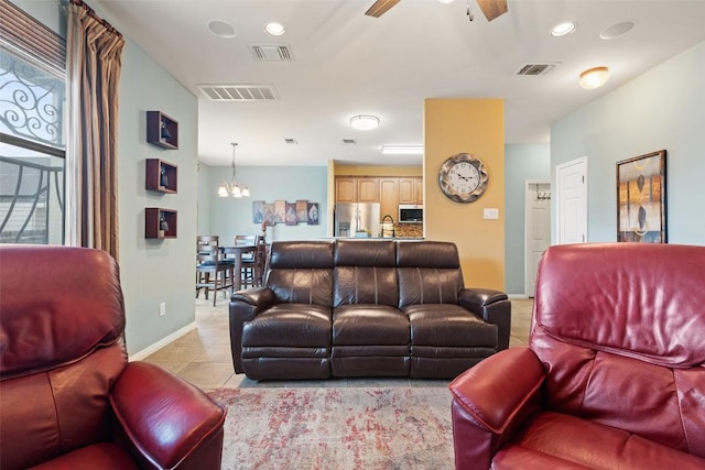 6006 Seville Dr, Austin, TX 78724 - living area featuring visible vents, light tile patterned floors, and ceiling fan with notable chandelier