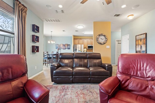 6006 Seville Dr, Austin, TX 78724 - living room featuring a chandelier, a ceiling fan, and light tile patterned flooring