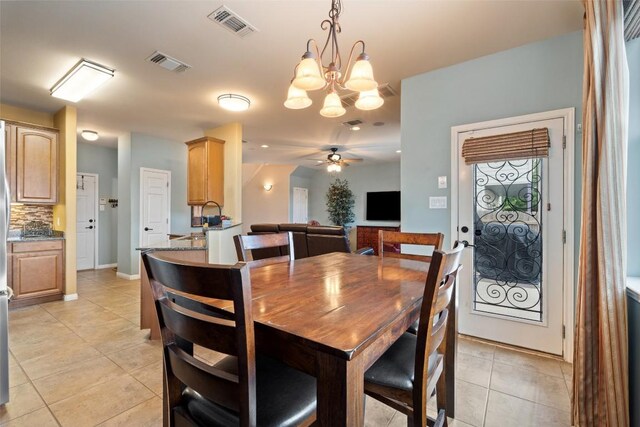 6006 Seville Dr, Austin, TX 78724 - dining space featuring light tile patterned floors, a chandelier, and ceiling fan