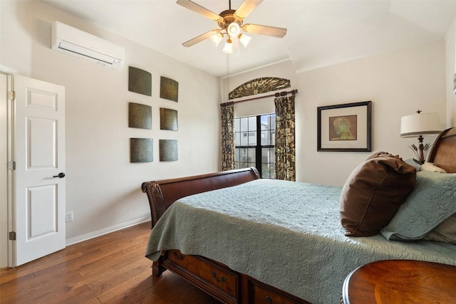 6006 Seville Dr, Austin, TX 78724 - bedroom featuring a wall mounted air conditioner, wood finished floors, and a ceiling fan