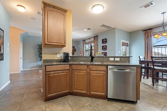 6006 Seville Dr, Austin, TX 78724 - kitchen featuring stainless steel dishwasher, a sink, dark stone counters, and visible vents