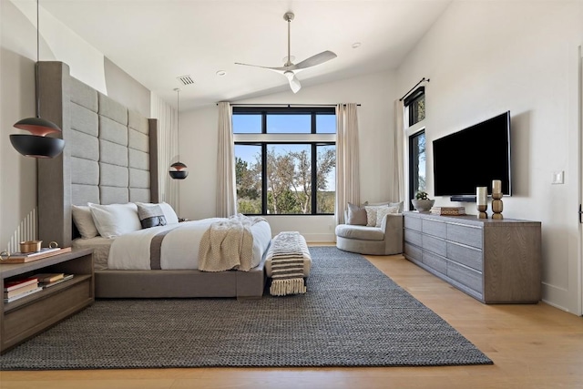 bedroom with ceiling fan, light wood-style floors, baseboards, lofted ceiling, and visible vents