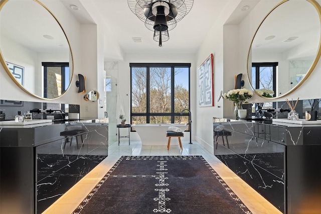 entryway with recessed lighting, baseboards, and marble finish floor